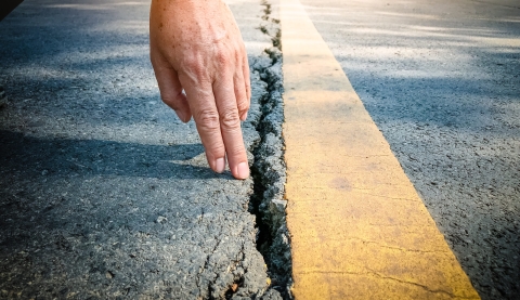 Inspector to check the surface of asphalt road.